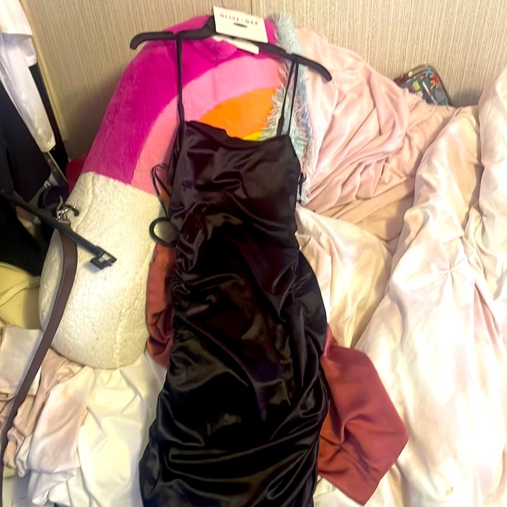 It is a tight fitting black dress and spaghetti strap